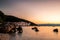 Beautiful pebbly beach in MoÅ¡Ä‡eniÄka Draga bay at sunrise, with historical town of Istria in the background, Croatia